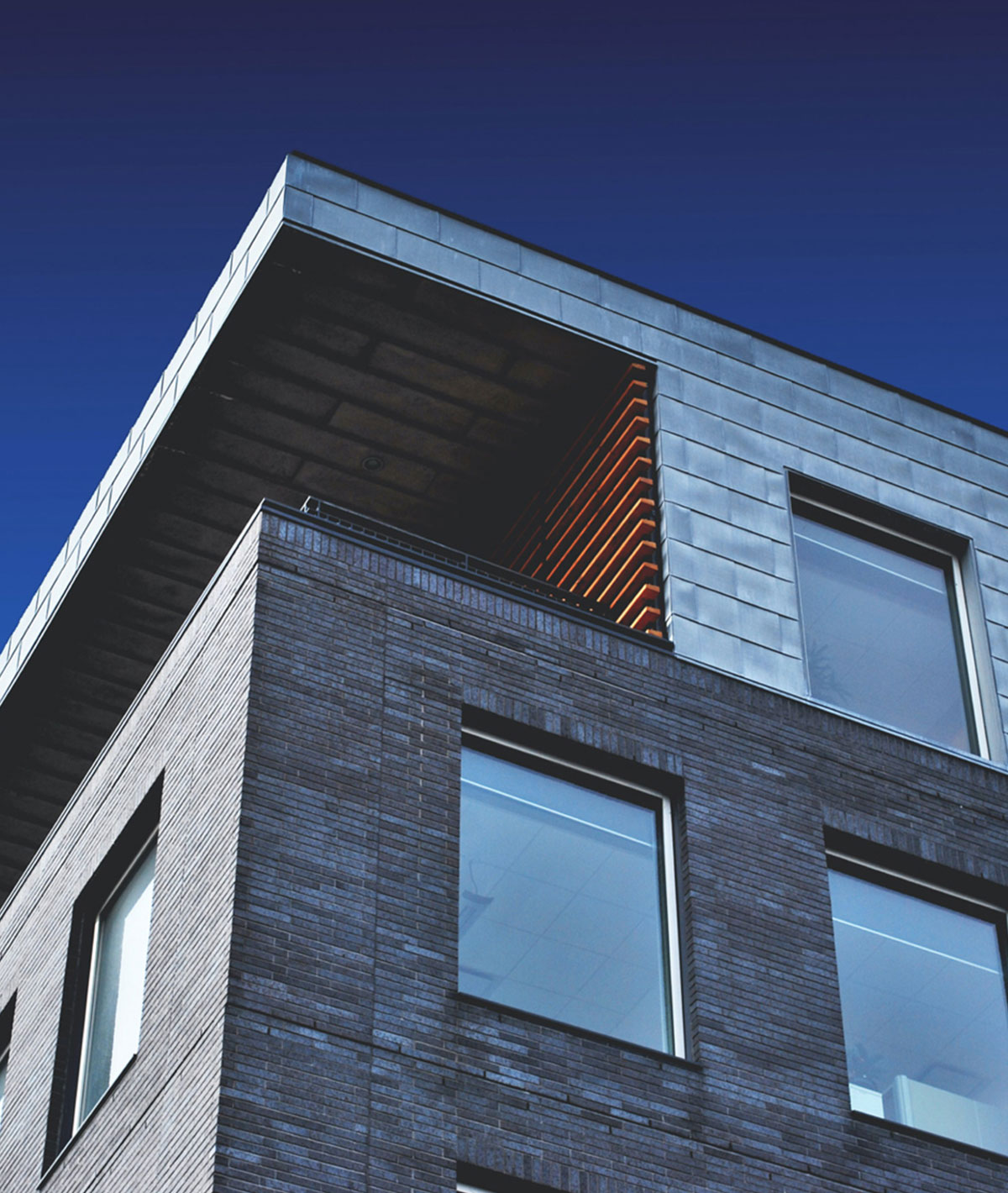 Modern apartment building with timber and metal cladding