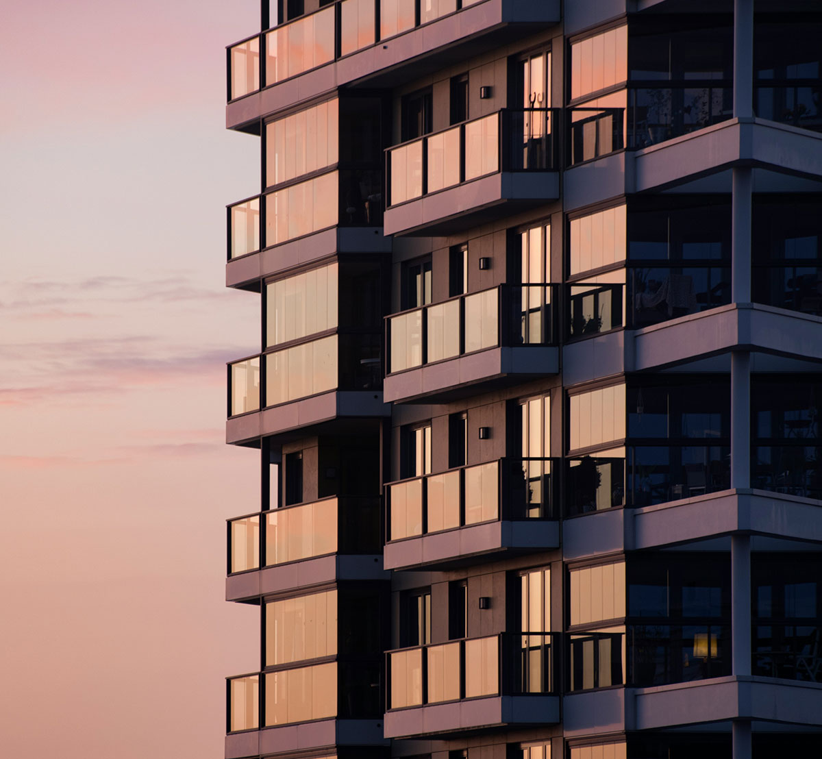 Apartment building with balconies in warm evening light