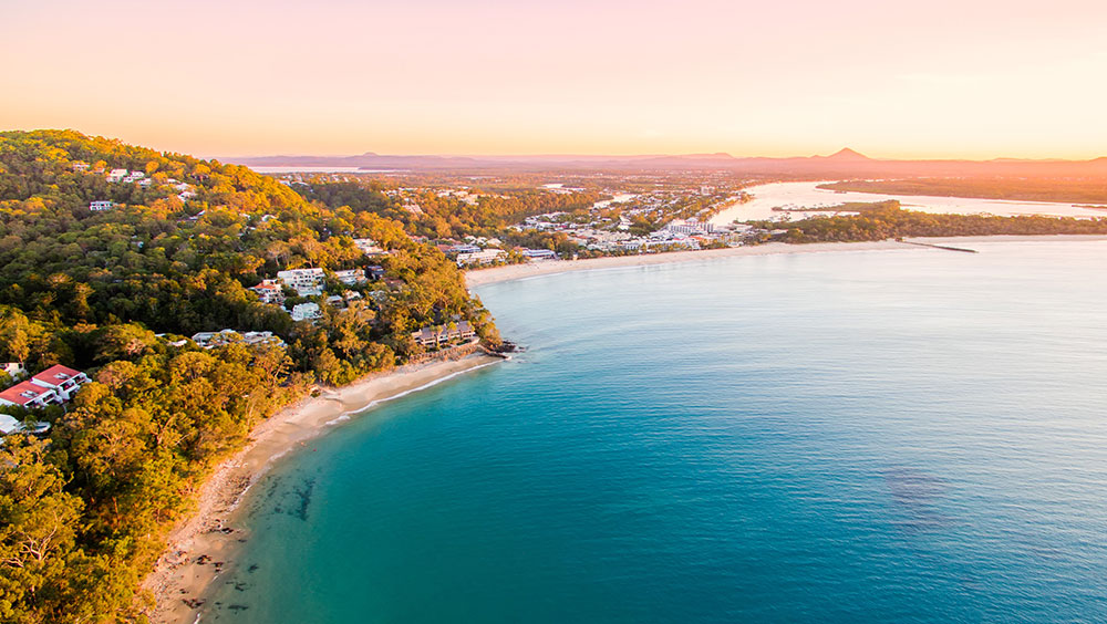 Sheltered beach and bay beside a wooded headland