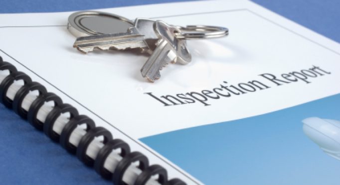 Brochure of Inspection Report, with keys on top. Our own photo on brochure so no copyright issues. Concepts of Home Inspection or House Check. Shallow DOF.