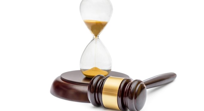 Judge's gavel with hourglass on white.